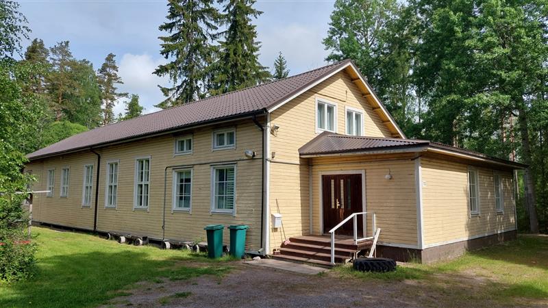 Rakennuksen tienpuoleista päätyä, johon sijoittuvat uudisosat. Vanhempi runko-osa taka-alalla.&nbsp;(Dan Ronimus&nbsp;06/2022)